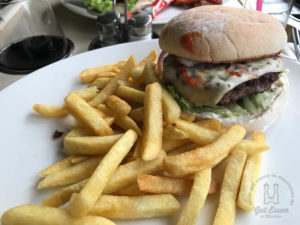 Cheeseburger vom Black-Angus-Rind mit Tomate, Salat, roter Zwiebel und Pommes